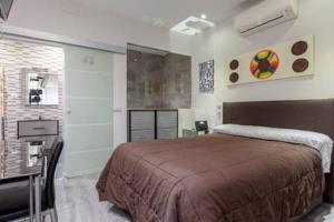 a bedroom with a bed and a sink in a room at Malasaña & Plaza España in Madrid