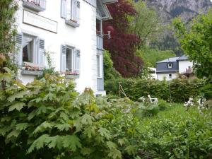 a white house with a garden in front of it at Romantic-Pension Albrecht - since 1901 in Hohenschwangau