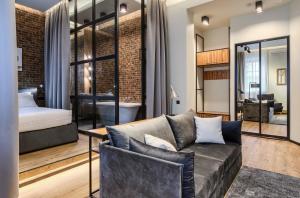 a living room with a couch and a bedroom at Number 21 by DBI in Kyiv