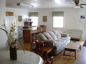 a living room with a couch and a table at Lakeview Motel & Apartments in Massena