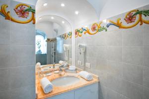 a bathroom with a sink and a mirror at Villa Yiara in Positano +115 photos
