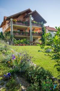 a house with a garden in front of it at Guest House Nena Rastoke in Slunj