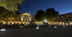 a building with a fountain in front of it at night at Hôtel Le G (ex Le Genève) in Nice