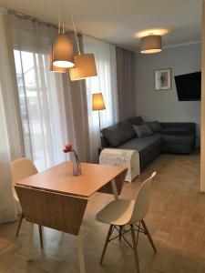 a living room filled with furniture and a table at Best Choice Terrace FREE Parking in Graz