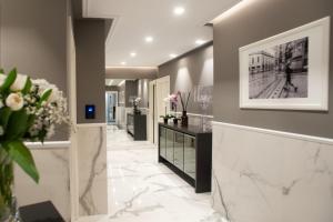 a lobby with marble floors and a picture on the wall at The Unique in Milan