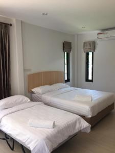 Tempat tidur dalam kamar di Bulan Villa rayong