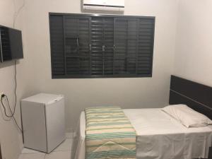Un pat sau paturi într-o cameră la Residence Hotel Ltda