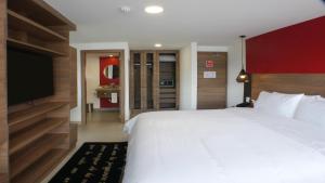 a bedroom with a bed and a dresser at Park Inn by Radisson Quito in Quito