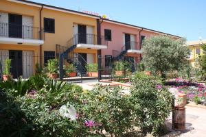 a building with flowers in front of it at Case Vacanze Ancora in Porto Empedocle