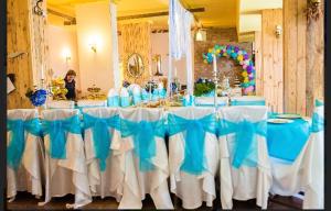 a long table with blue and white table cloth at Hotel Shterev Sopot in Sopot