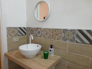 a bathroom with a white sink and a mirror at APPARTAMENTO IN CENTRO in Marsala