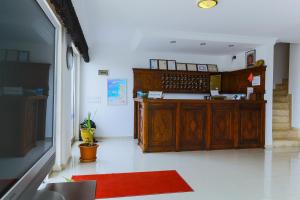 a kitchen with wooden cabinets and a red rug at Belinda Hotel in Kaş