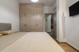 Postel nebo postele na pokoji v ubytování Oresteia Downtown Apartment