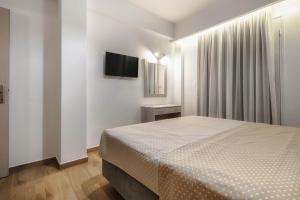 Postel nebo postele na pokoji v ubytování Oresteia Downtown Apartment