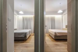 Postel nebo postele na pokoji v ubytování Oresteia Downtown Apartment
