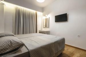 Postel nebo postele na pokoji v ubytování Oresteia Downtown Apartment