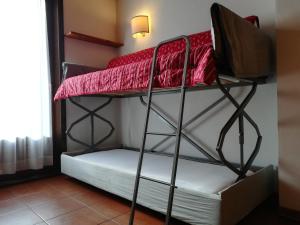 a couple of bunk beds in a room at Residence Borgo al Sole in Sappada