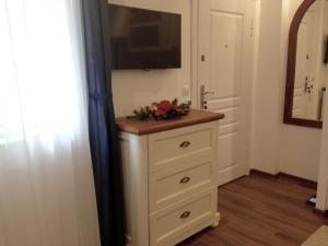 a bathroom with a dresser with a television on it at Guest Rooms Boutique Varna in Varna City +45 photos