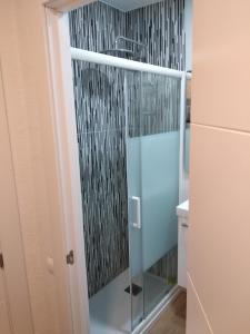 a bathroom with a glass door and a shower curtain at Hostal Restaurante Cornella in Cornellà de Llobregat