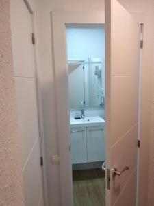 a bathroom with a sink and a mirror at Hostal Restaurante Cornella in Cornellà de Llobregat