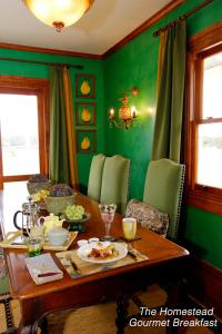 a green dining room with a table with food on it at Tracy's Boutique B&B Farmstay in Wellsford