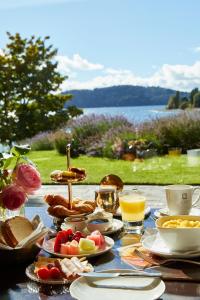 a table with breakfast foods and drinks on it at El Casco Art Hotel in San Carlos de Bariloche
