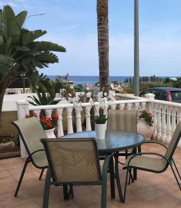 a table and chairs on a balcony with the ocean at Villa Emiliana in Paralimni