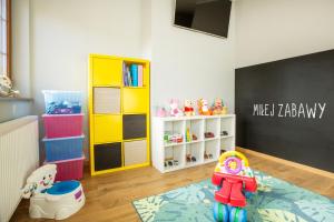 a childs room with a black chalkboard and a play area at Willa Ostoja Wellness in Świeradów-Zdrój