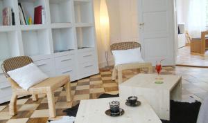 a living room with two chairs and a coffee table at B&B Laupenring, Basel in Basel +20 photos