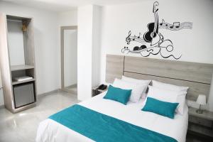 Postel nebo postele na pokoji v ubytování Hotel Milla de Oro Uraba