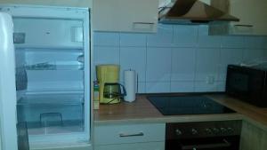 a kitchen with a counter top with an open refrigerator at Ferienwohnung Klaus in Oberhausen