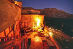 a balcony of a building with a table and chairs at Ayouze Auberge in Aït Ben Haddou