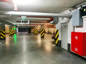 an empty parking garage with a car parked in it at Apartimento Naturale in Wrocław
