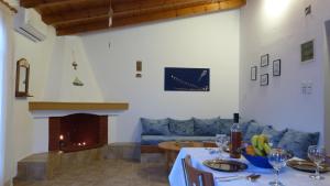 a living room with a table and a fireplace at Theathina in Kalamaki