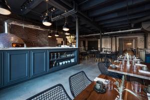 a restaurant with blue cabinets and tables and chairs at Crossroads Hotel in Kansas City
