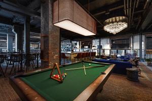 a billiard room with a pool table in a restaurant at Crossroads Hotel in Kansas City