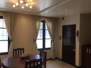 a dining room with a table and a chandelier at Las Piedras Desing III in San Miguel de Tucumán