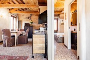 a room with a dining table and a room with a bedroom at Ca' Del Mariner apartment with Terrace in Venice