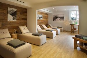 a living room with three couches and a table at Hotel Menning ***S in Oberstdorf