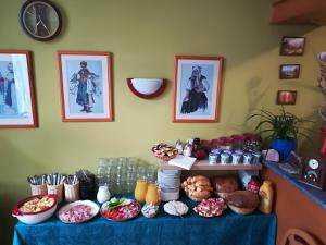 a table with a blue table cloth with food on it at Penzión Rodina in Levoča