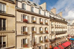 a building with flower boxes on the side of it at Hôtel du Levant in Paris