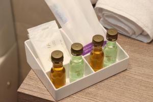 three bottles of essential oils in a box on a table at Apartamentos turísticos Desiree in Arévalo