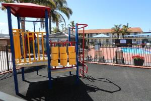 a playground in front of a swimming pool at Aquarius Merimbula in Merimbula