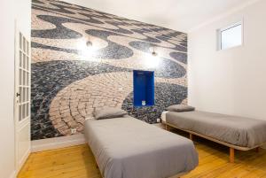 Un ou plusieurs lits dans un hébergement de l'établissement Calçada do Combro