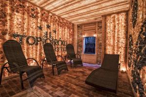 a room with chairs and a wall covered in wallpaper at Hotel Toporów in Białka Tatrzanska