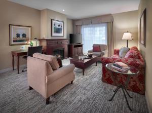 a living room with a couch and a fireplace at Residences at the Sun Peaks Grand in Sun Peaks
