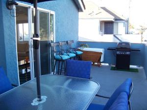 a table and chairs on a patio with a grill at Beach House in Newport Beach