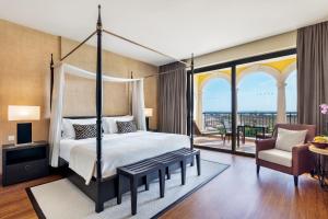 a bedroom with a canopy bed and a balcony at Cascade Wellness Resort in Lagos