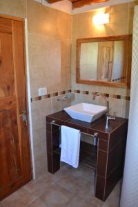a bathroom with a sink and a mirror at Cabaña en El Hoyo in El Hoyo