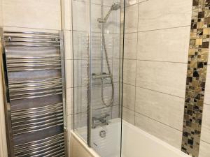 a shower with a glass door in a bathroom at Ilfracombe House Hotel - near Cliffs Pavilion in Southend-on-Sea